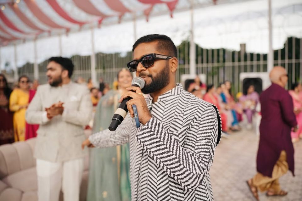 Akshay on the mic at a celebration